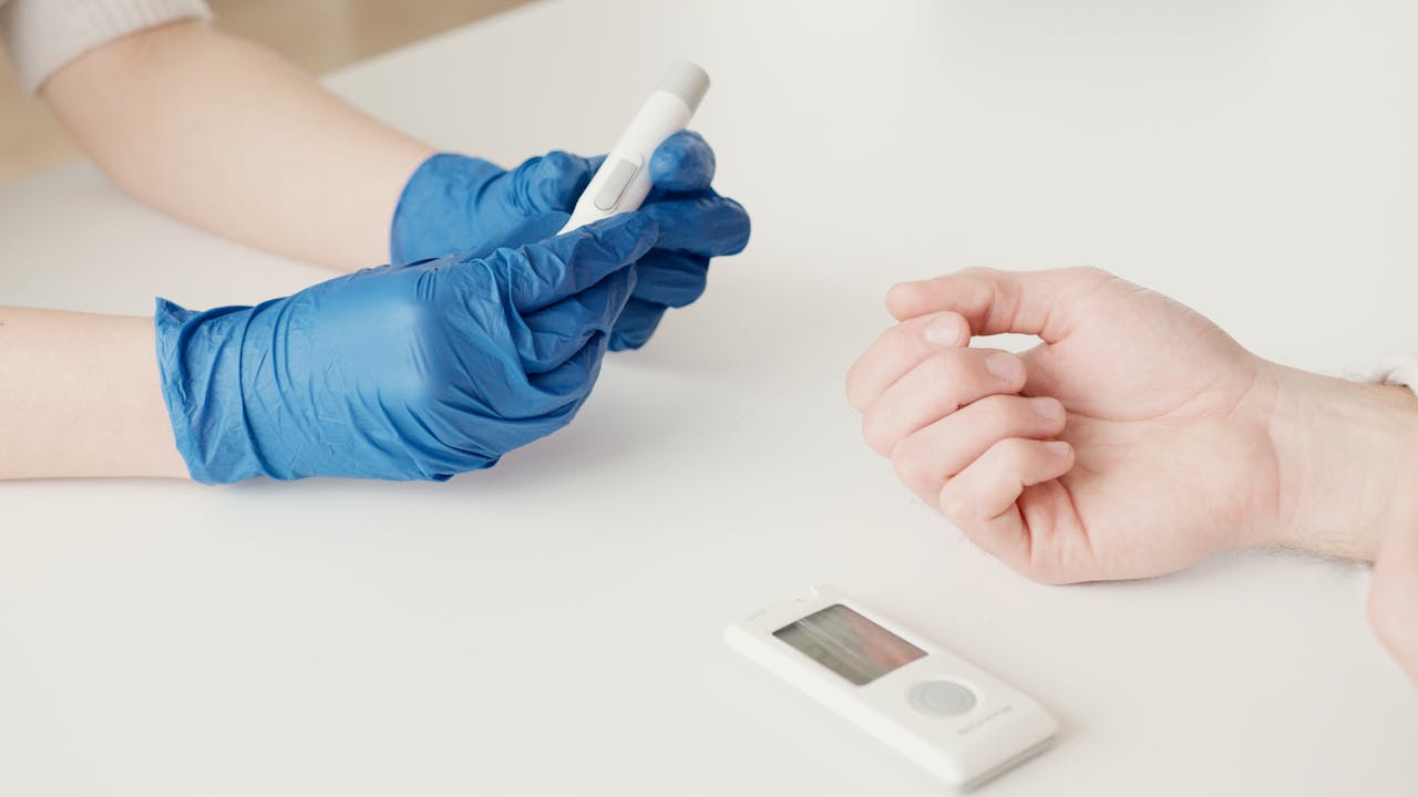 A woman monitoring her blood sugar levels with a glucose meter