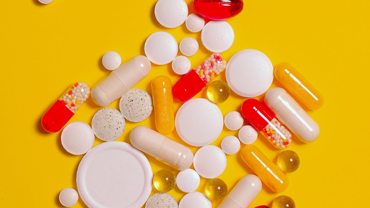Spermidine supplement capsules and wheat germ on a marble surface