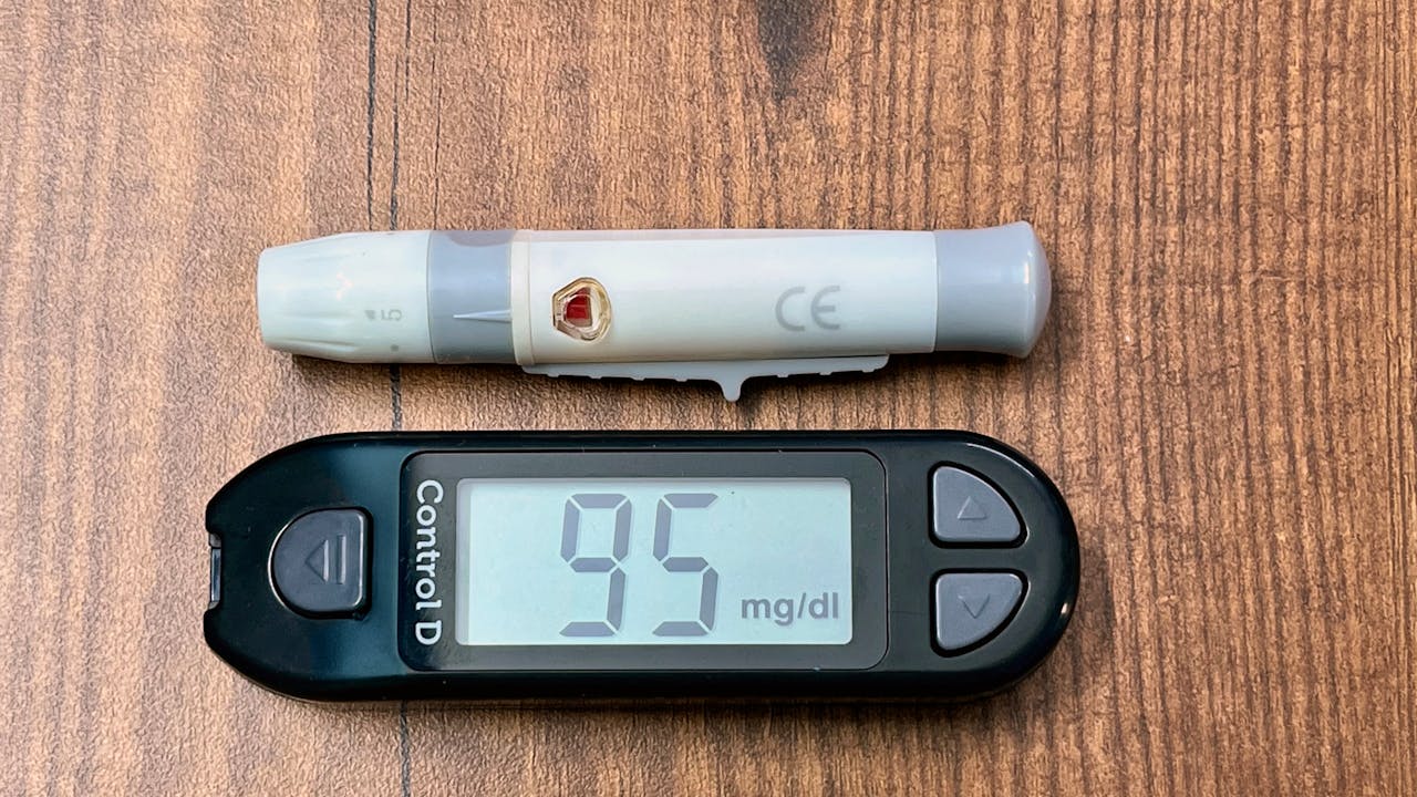 Blood glucose test with glucometer, representing blood sugar monitoring and management