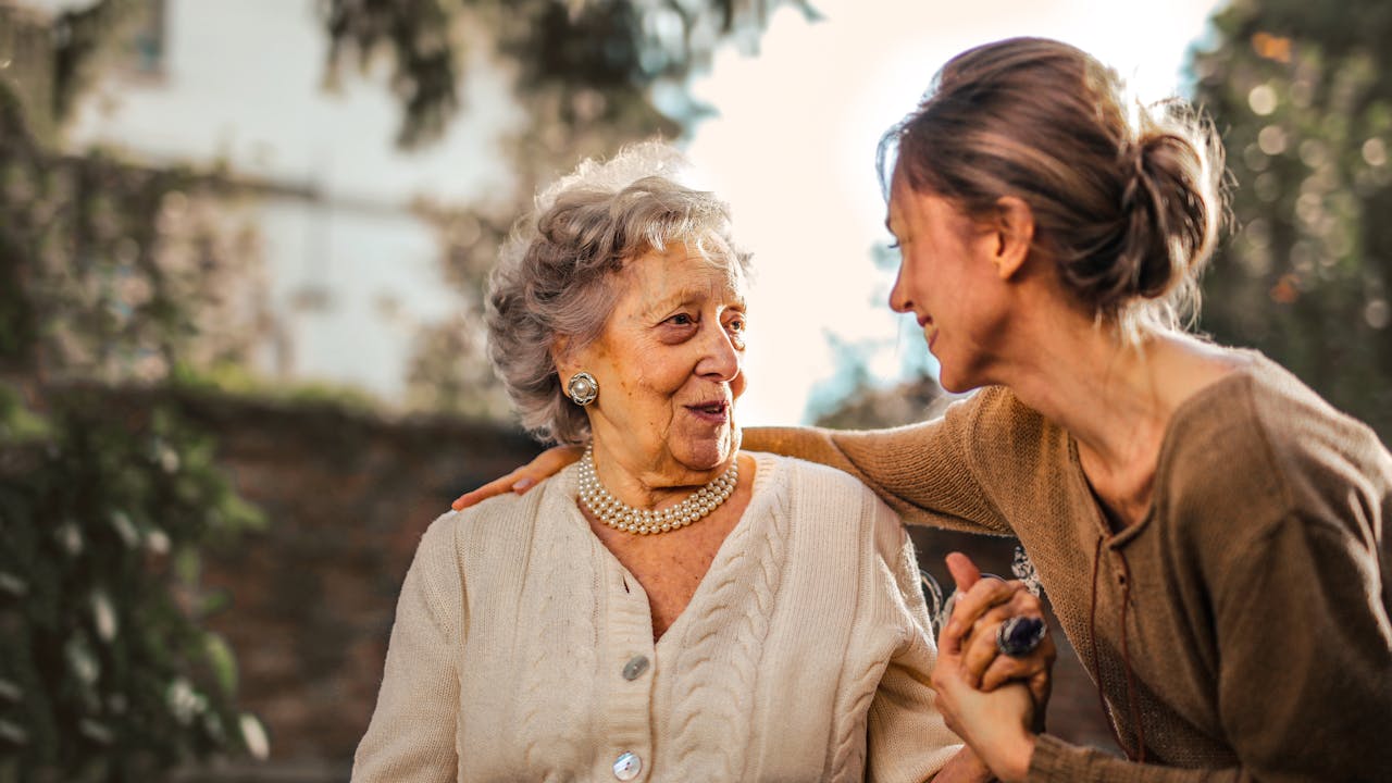 Healthy older adults walking outdoors in warm light, representing active longevity