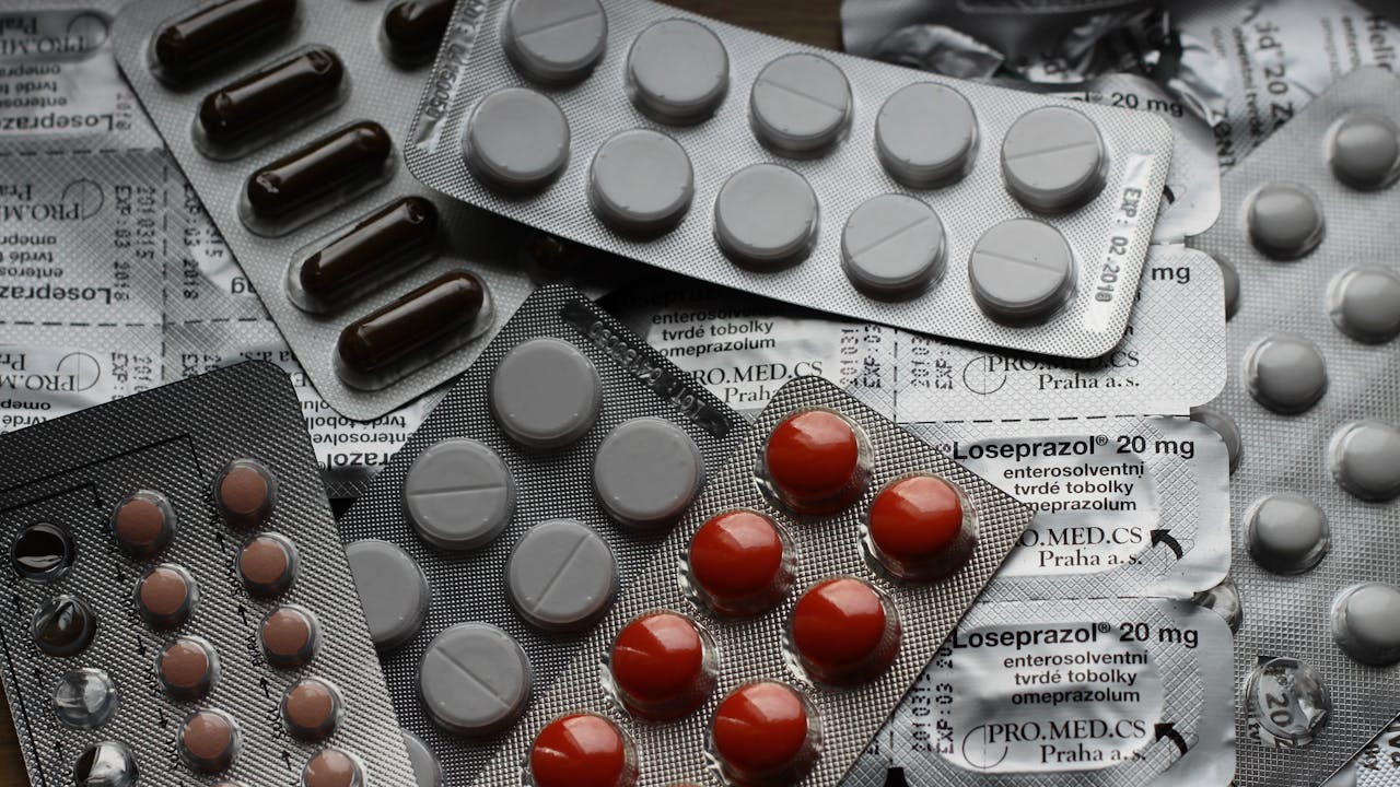 Rows of medicine bottles on pharmacy shelves