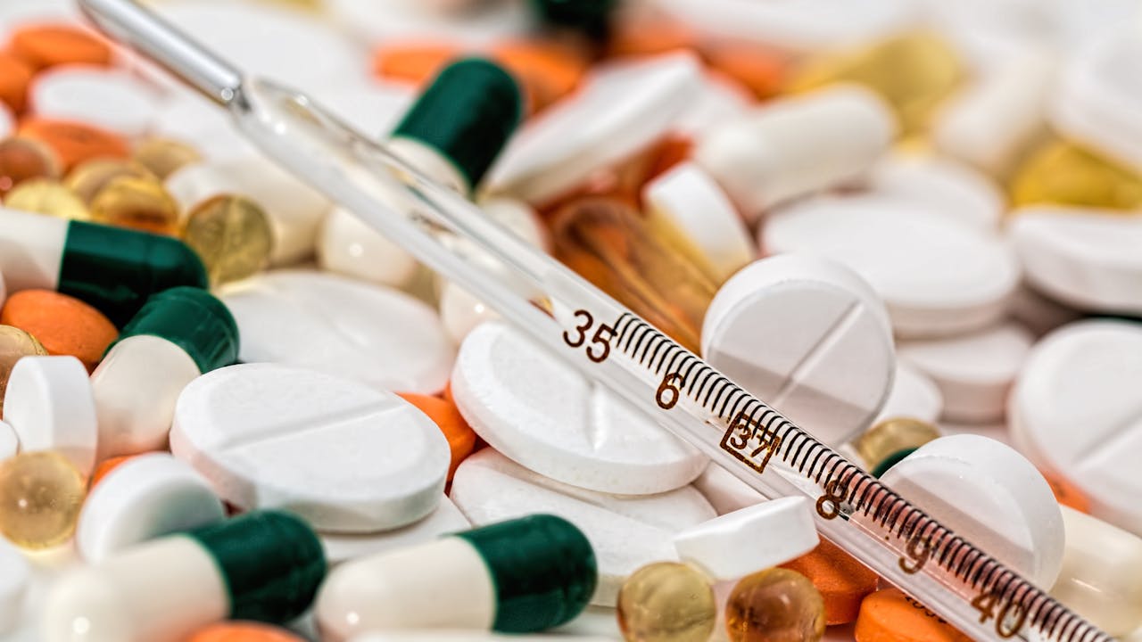Hands holding small pharmaceutical grade troches with clean minimal background