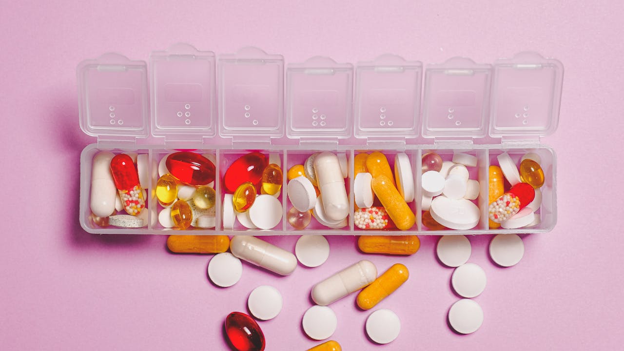 NMN supplement capsules arranged on a clean white surface with green botanical elements